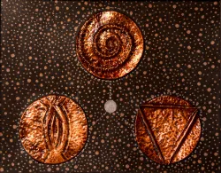 image shows three copper medallions with ancient designs arranged on a mount