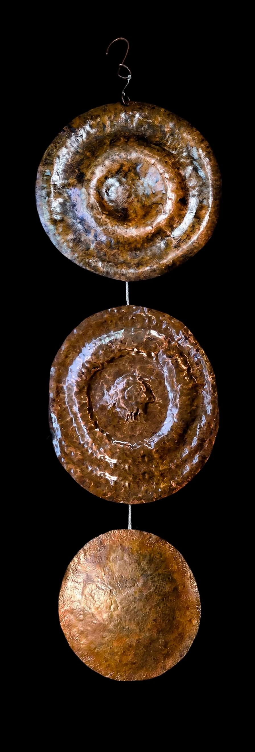 Hanging pounded copper disks